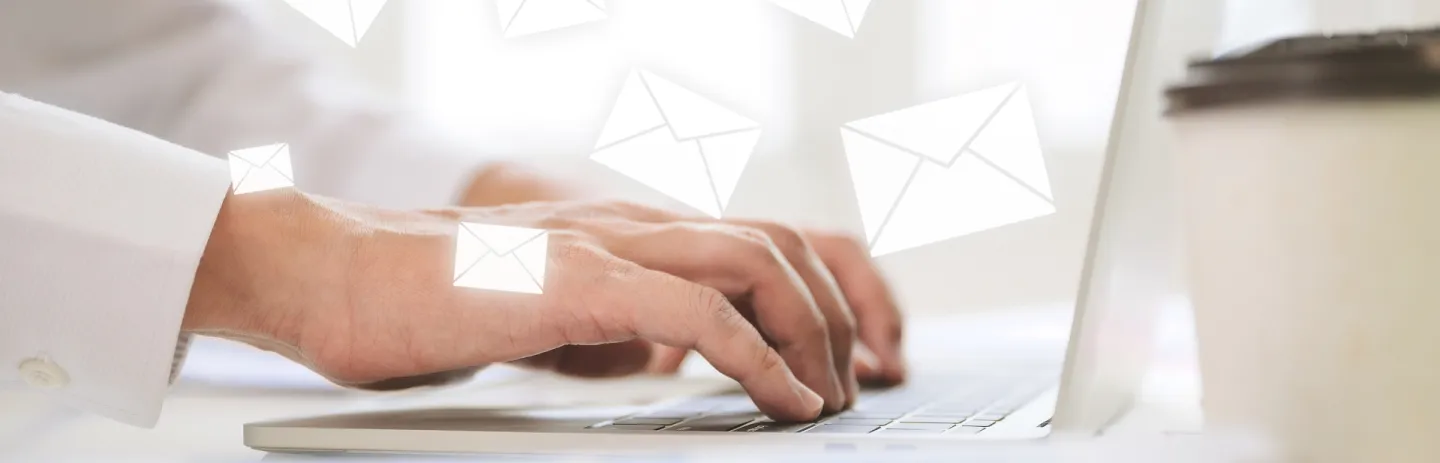 Dentist reviewing email campaign dashboard on tablet while team plans patient reminders and promotions