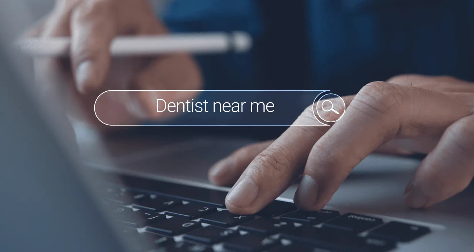 Dentist reviewing keyword research charts on laptop, analyzing local search terms to attract new patients online visually