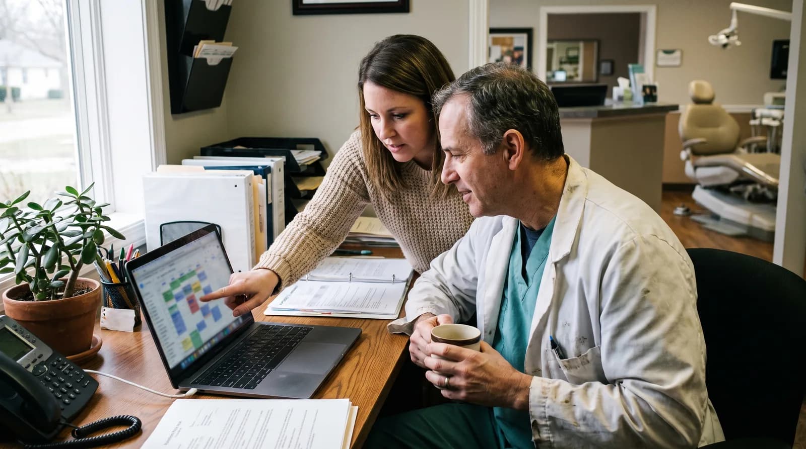 Dental no-show reduction case study: front desk reviewing an automated appointment reminder schedule