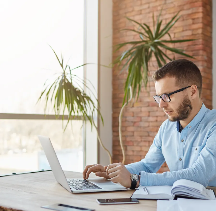 Person working on a laptop in an office